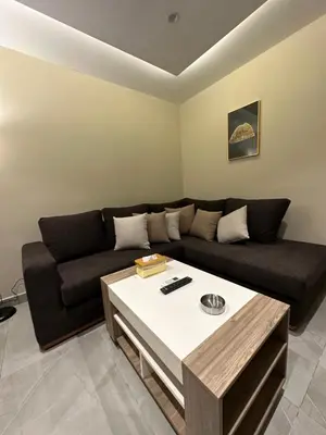 a living room with a couch and a table at Chic Apartments For Rent ave0-3 in Amman