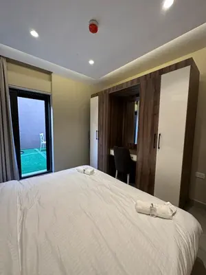 a bedroom with a large white bed with a window at Chic Apartments For Rent ave0-3 in Amman