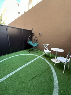a patio with a swing and a table and chairs at Chic Apartments For Rent ave0-3 in Amman