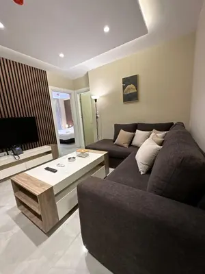 a living room with a couch and a coffee table at Chic Apartments For Rent ave0-6 in Amman