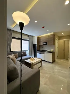 a living room with a couch and a kitchen at Chic Apartments For Rent ave0-9 in Amman