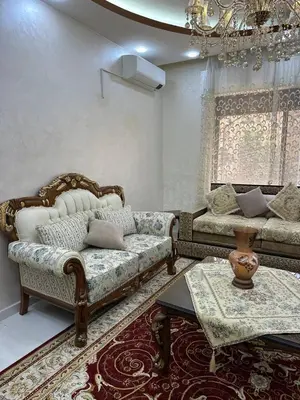 a living room with two couches and a chandelier at شقة مفرشة في الرابية 3 غرف نوم in Amman