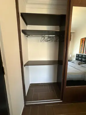 a walk in closet in a bedroom with a bed at Secured Compound Hill-view Terrace in Amman