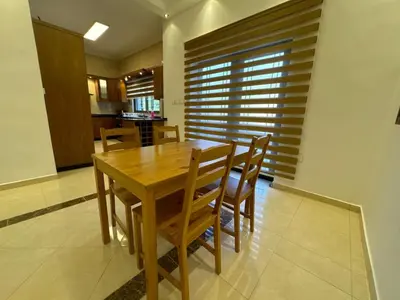 a dining room with a wooden table and chairs at Secured Compound Hill-view Terrace in Amman