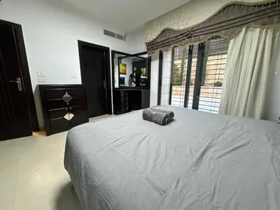 a bedroom with a large bed and a large window at 2 En-suite Rooms, Central & Garden Terrace in Amman
