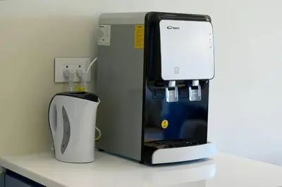 a coffeemaker and a coffee maker on a counter at Luxury Apt with Private Beach In Ayla in Aqaba
