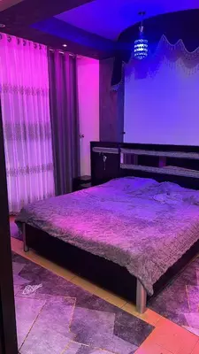 a bedroom with a large bed with purple lighting at شقةارضية فاخرة مفروشة عمان ضاحية الرشيد in Ţāb Kirā‘