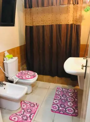 a bathroom with a toilet and a sink at شقةارضية فاخرة مفروشة عمان ضاحية الرشيد in Ţāb Kirā‘