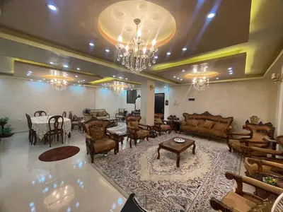 a large living room with tables and chairs and a chandelier at Luxury Duplex In the center of Irbid -Spacious 4BR in Irbid