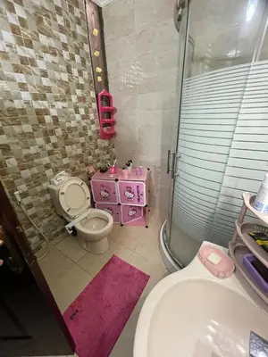a bathroom with a toilet and a sink and a shower at Luxury Duplex In the center of Irbid -Spacious 4BR in Irbid
