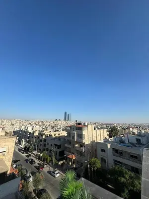 an aerial view of a city with buildings at The Roof Top Lounge in Umm Uthainah