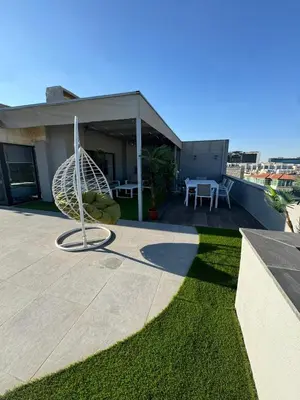 a metal sculpture on the roof of a house at The Roof Top Lounge in Umm Uthainah