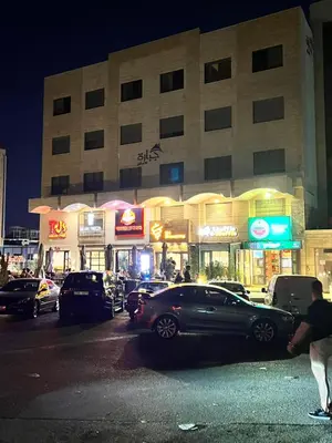 a parking lot with cars parked in front of a building at Cozy & Comfortable Studio in the heart of Amman, Studio #17 in Umm Uthainah