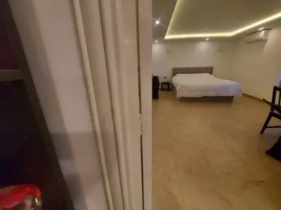 a bedroom with a white bed and a bed sqor at The view IVI in Umm Uthainah