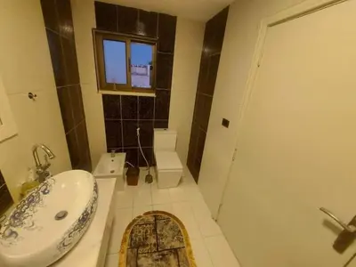 a bathroom with a sink and a toilet and a shower at The view IVI in Umm Uthainah