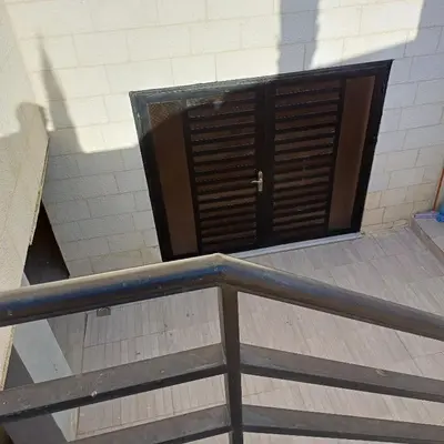 a door in the middle of a stairway with at Laperla family apartment 1 in Al Yādūdah