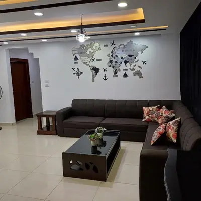 a living room with a couch and a map on the wall at Laperla family apartment 1 in Al Yādūdah