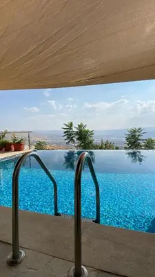 a swimming pool with a view of the water at villa rose3 in Mūbiş