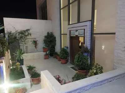 a building with a bunch of potted plants outside of it at villa rose3 in Mūbiş