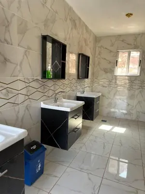 a bathroom with two sinks and two mirrors at Bedouin Camp&tour in Wadi Rum