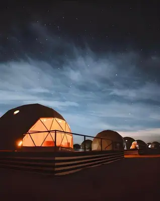 a group of domes at night with the sky at Bedouin Camp&tour in Wadi Rum