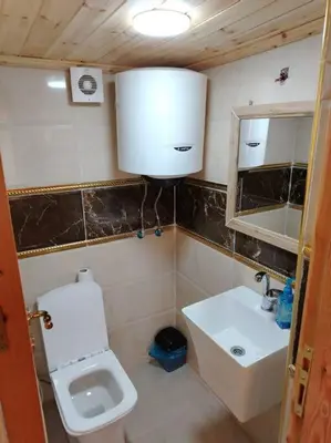 a small bathroom with a toilet and a sink at أكواخ وشقق كرم العنب عجلون in ‘Ayn Jannā