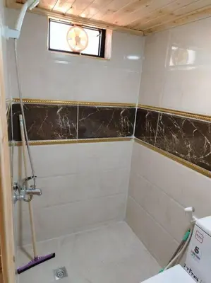 a bathroom with a shower and a window at أكواخ وشقق كرم العنب عجلون in ‘Ayn Jannā