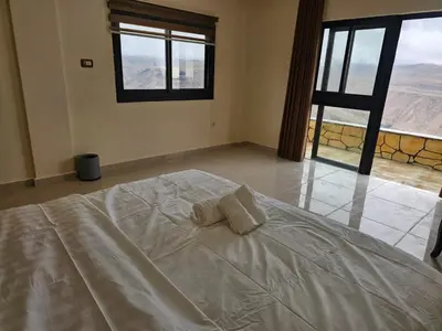 a bedroom with a bed with two towels on it at Ramses Tafilah Lodge نزل رمسيس الطفيلة in At-Tafilah
