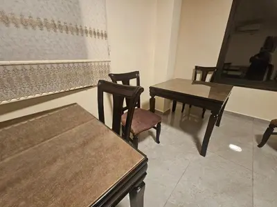 a group of tables and chairs in a room at Ramses Tafilah Lodge نزل رمسيس الطفيلة in At-Tafilah