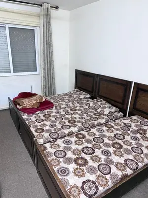 a large bed in a bedroom with a bedspread at شقة مفروشة للايجار اسبوعي شهري سنوي طبربور in ‘Urjān al Gharbīyah