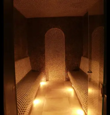 a dark room with two benches and lights at Open sooq in Al Bunayyāt ash Shamālīyah