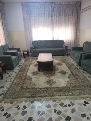 a living room with a couch and a coffee table at Al Otaibi in Umm Uthainah