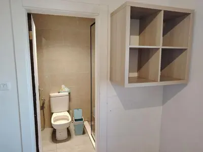 a small bathroom with a toilet and a cabinet at Cozy modern 2 bedroom apartment in Amman