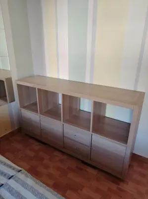 a wooden shelf in a room with a table at Cozy modern 2 bedroom apartment in Amman