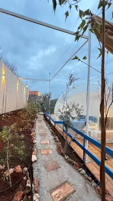 a blue fence next to a body of water at منتجع برمودا Bermuda resort in Ajloun
