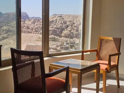 a room with two chairs and a table and a window at Petra Summit Hotel in Petra