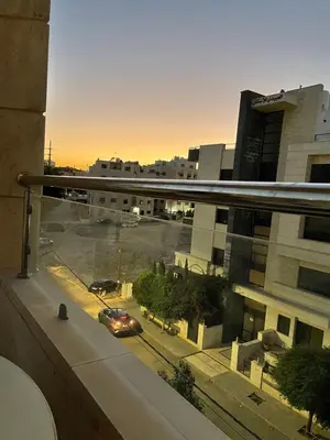 a view from a window of a parking lot with a car at السابع in Amman