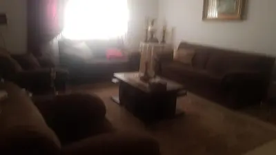 a living room with a couch and a table at ram77 in Al Salt