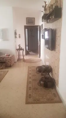 a living room with a rug on the floor at ram77 in Al Salt