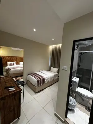 a hotel room with two beds and a bathroom at Jawad Hotel by Sandra in Amman