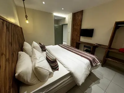 a bedroom with a bed with white sheets and pillows at Jawad Hotel by Sandra in Amman