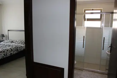 a door leading to a bedroom with a bed at Cosy appartement in Umm Uthainah
