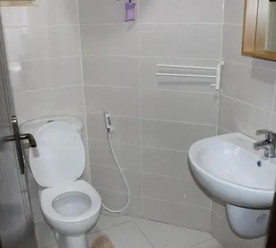 a bathroom with a toilet and a sink at Cosy appartement in Umm Uthainah
