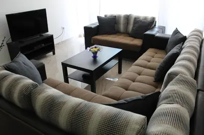 a living room with two couches and a coffee table at Cosy appartement in Umm Uthainah