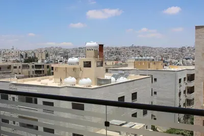 a view of the city from the roof of a building at Cosy appartement in Umm Uthainah