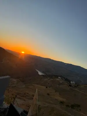 a view of the sunset from the top of a hill at شاليه بيت التل HILLHOUSE Chalet in Al Maşţabah