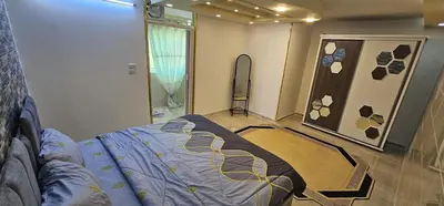 a bedroom with a bed in a room with a window at ستوديو مستقل داخل فيلا in Amman