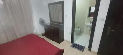 a bathroom with a bed and a sink and a mirror at Furniture apartment for families 3 bedroom in Al Bunayyāt ash Shamālīyah