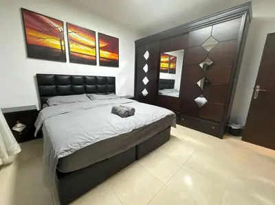 a bedroom with a bed with a stuffed animal on it at 2 En-suite Rooms, Central & Spacious in Amman