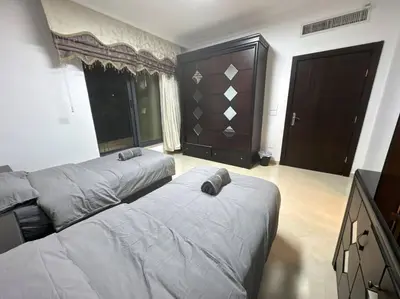 a bedroom with two beds and a tv in it at 2 En-suite Rooms, Central & Spacious in Amman